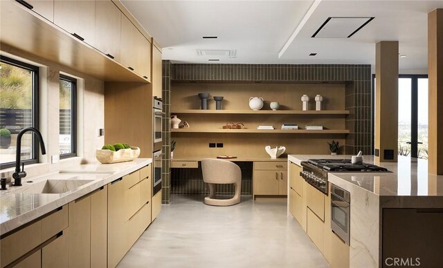 kitchen with sink, light brown cabinets, light stone countertops, and stainless steel appliances