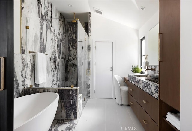 bathroom with vanity, vaulted ceiling, plus walk in shower, and tile walls