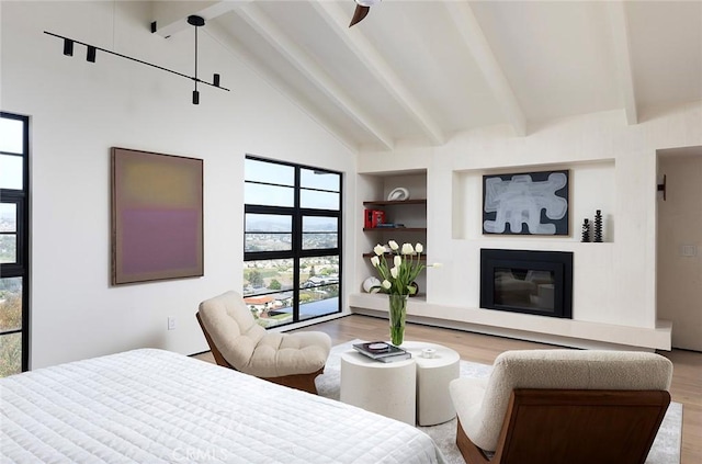 bedroom featuring high vaulted ceiling, hardwood / wood-style floors, and beam ceiling