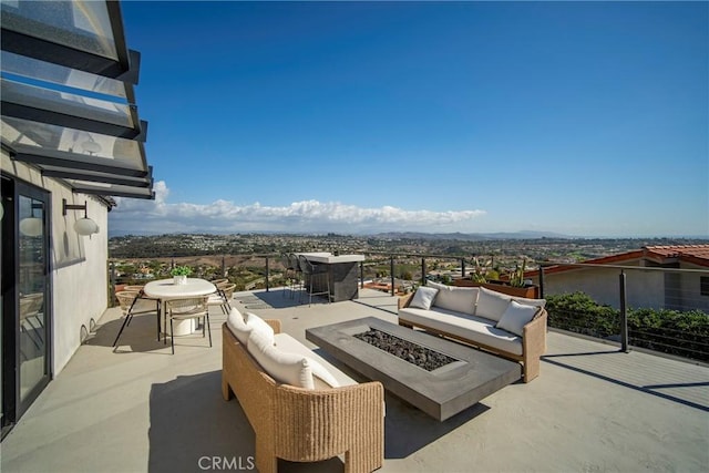 view of patio featuring an outdoor living space with a fire pit