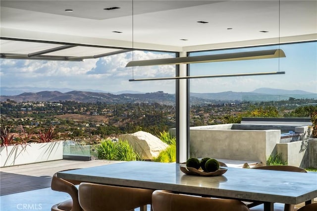 interior space with expansive windows and a mountain view