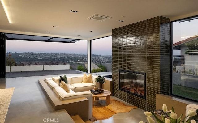 interior space with a patio and an outdoor living space with a fireplace