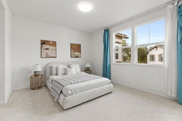 bedroom with light colored carpet