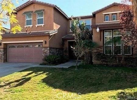 view of front of home featuring a garage and a front yard