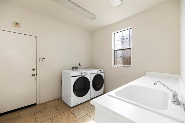 washroom featuring washer and dryer, sink, and light tile patterned floors