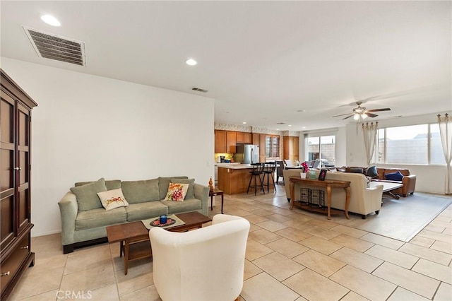 living room featuring ceiling fan and light tile patterned flooring