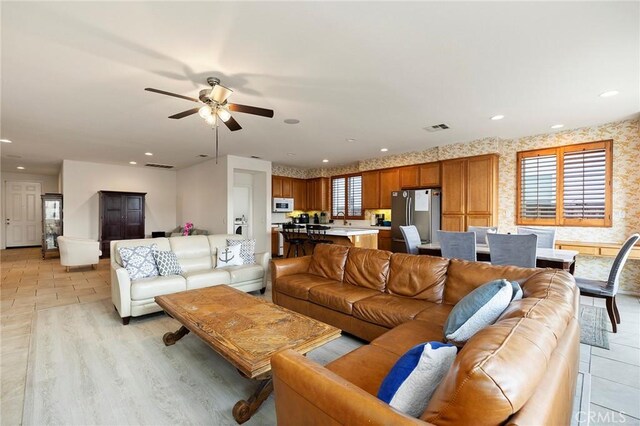 living room featuring sink and ceiling fan