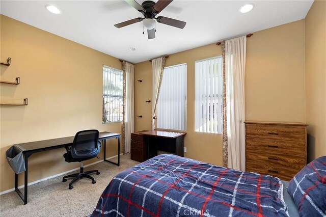 bedroom featuring light colored carpet and ceiling fan