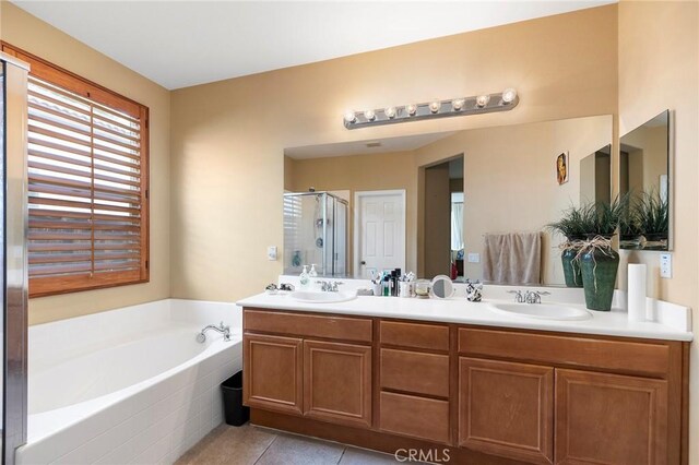 bathroom featuring vanity, tile patterned flooring, and plus walk in shower