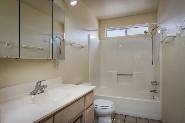 full bathroom with tile patterned flooring, vanity, washtub / shower combination, and toilet