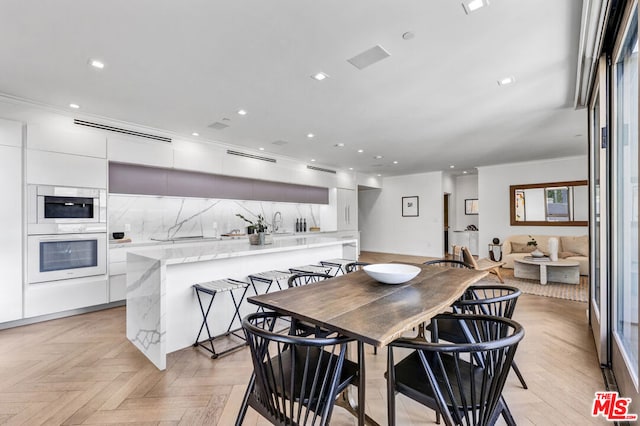 dining room featuring light parquet flooring