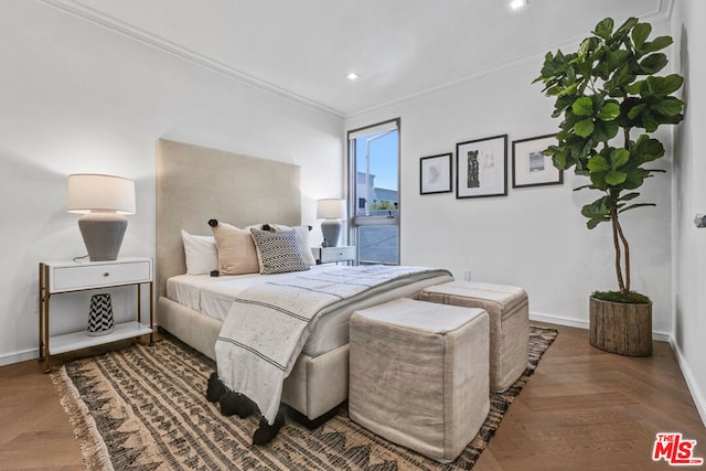 bedroom featuring dark parquet flooring and ornamental molding