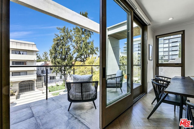 doorway to outside featuring crown molding