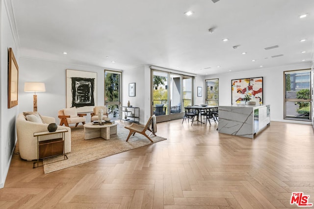 living room featuring ornamental molding and light parquet floors