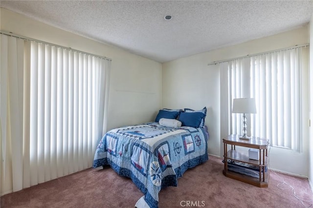 bedroom featuring carpet floors and a textured ceiling