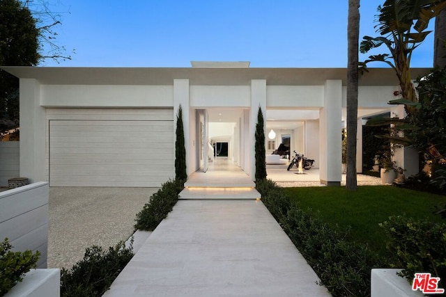 view of front of house with a garage and a front lawn