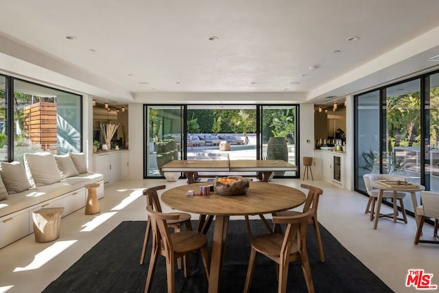 dining area with a healthy amount of sunlight and beverage cooler