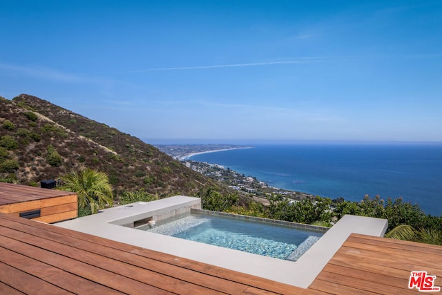 view of pool with a water view