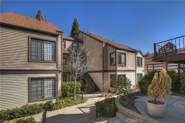 28050 State Highway 189 Unit 212, Lake Arrowhead, CA 92352 - rear view of property featuring stairs and a balcony