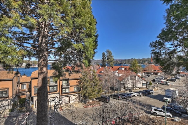 28050 State Highway 189 Unit 212, Lake Arrowhead, CA 92352 - view of building exterior with uncovered parking and a residential view