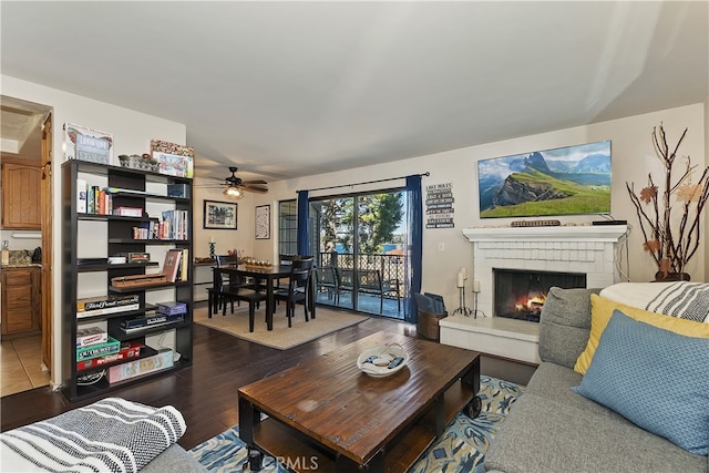 28050 State Highway 189 Unit 212, Lake Arrowhead, CA 92352 - living area featuring a ceiling fan, a fireplace, and dark wood-style flooring