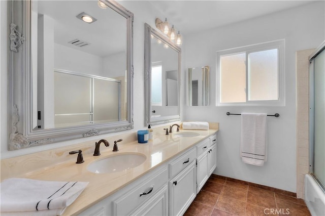 bathroom with vanity, shower / bath combination with glass door, and tile patterned flooring