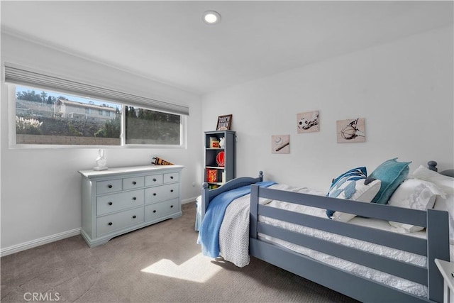 carpeted bedroom featuring multiple windows