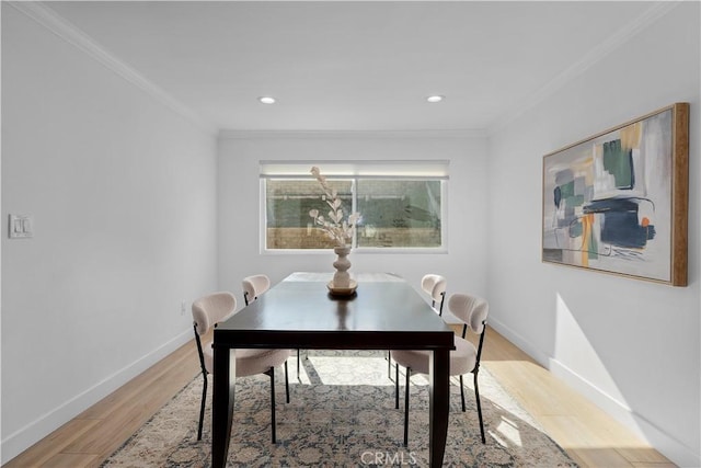 dining room with ornamental molding and hardwood / wood-style floors