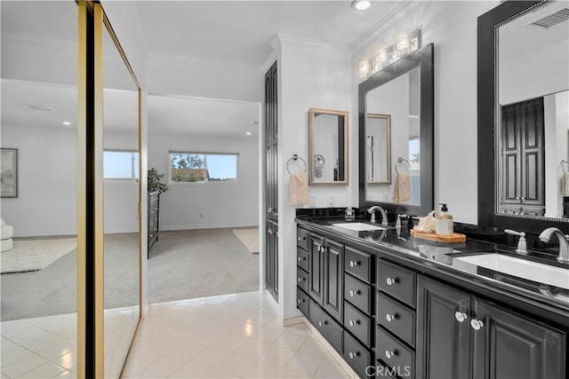 bathroom featuring tile patterned flooring, vanity, and ornamental molding