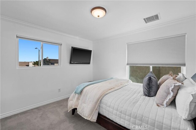 carpeted bedroom featuring ornamental molding