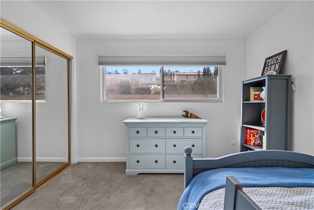 carpeted bedroom featuring multiple windows and a closet