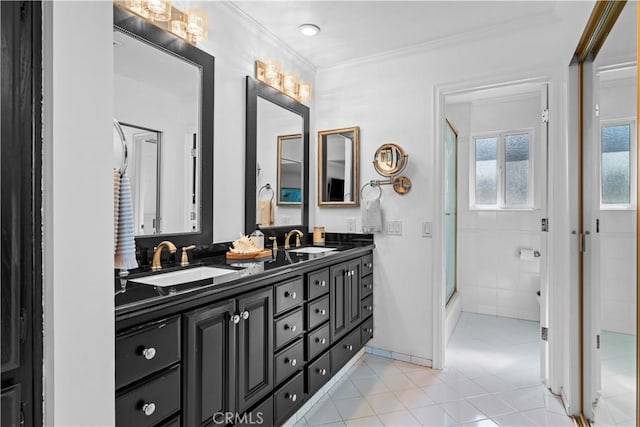 bathroom with a shower with door, ornamental molding, vanity, and tile patterned floors