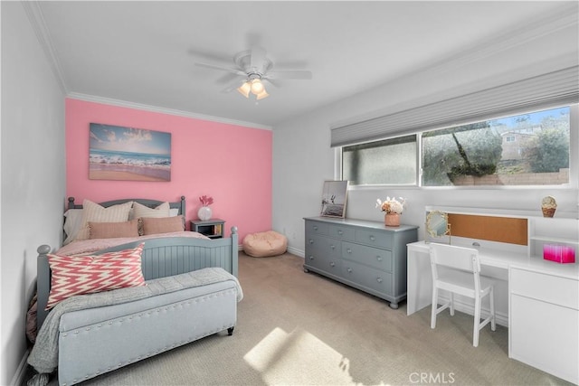 bedroom with crown molding, ceiling fan, built in desk, and light carpet