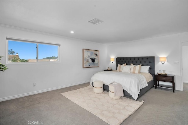 bedroom with ornamental molding and carpet