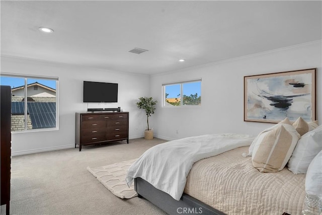 bedroom with crown molding and light colored carpet