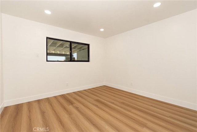 spare room with light hardwood / wood-style floors