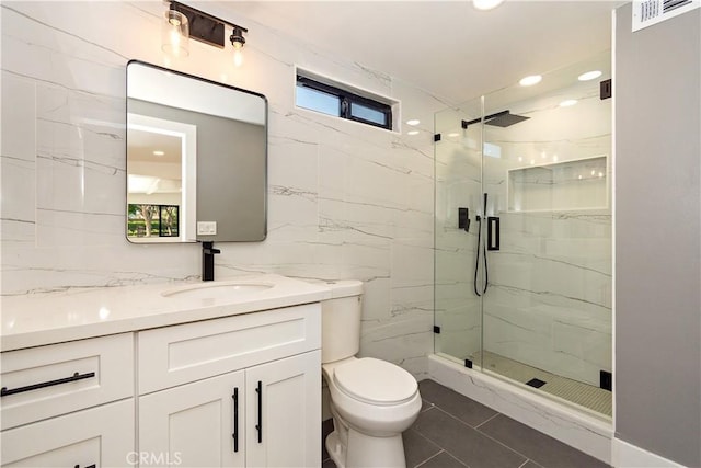 bathroom featuring vanity, tile walls, an enclosed shower, and toilet