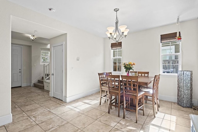 tiled dining area with a chandelier