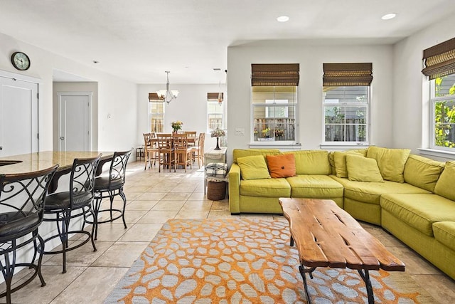 tiled living room featuring a notable chandelier