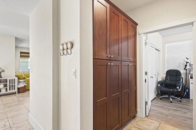 hall featuring light tile patterned floors