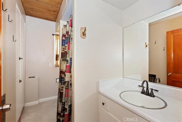 bathroom featuring wood ceiling and vanity