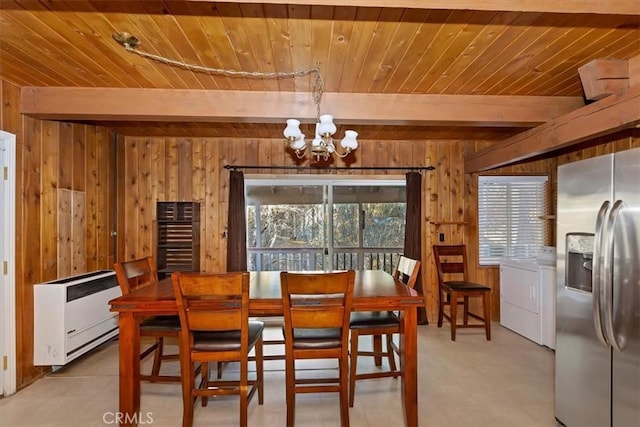 dining area featuring an inviting chandelier, beamed ceiling, a healthy amount of sunlight, and wood walls