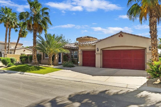 mediterranean / spanish-style home with a garage