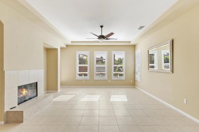 unfurnished living room with light tile patterned flooring, ceiling fan, and a fireplace