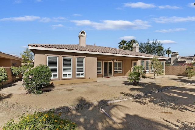 rear view of property with a patio area and ceiling fan