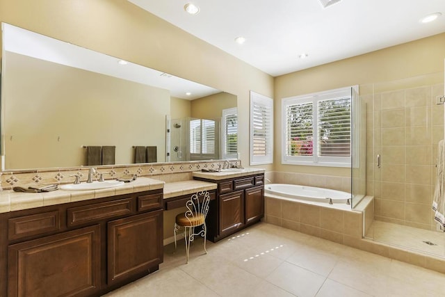 bathroom with tile patterned floors, plus walk in shower, and vanity