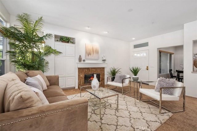 living area featuring a fireplace and light colored carpet