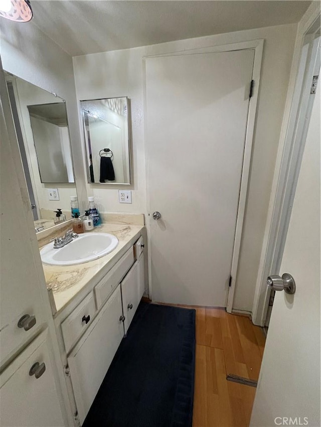 bathroom with hardwood / wood-style flooring and vanity