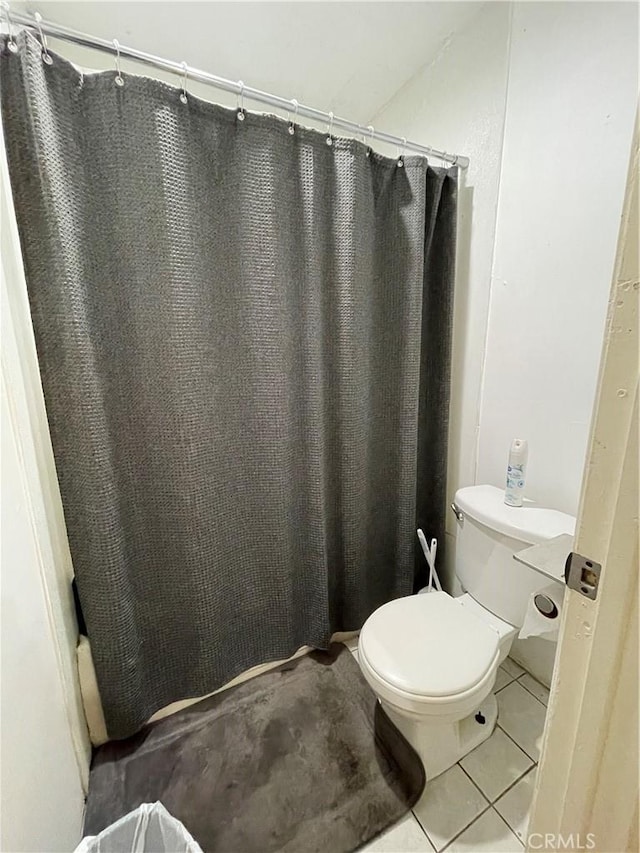 bathroom with tile patterned floors and toilet