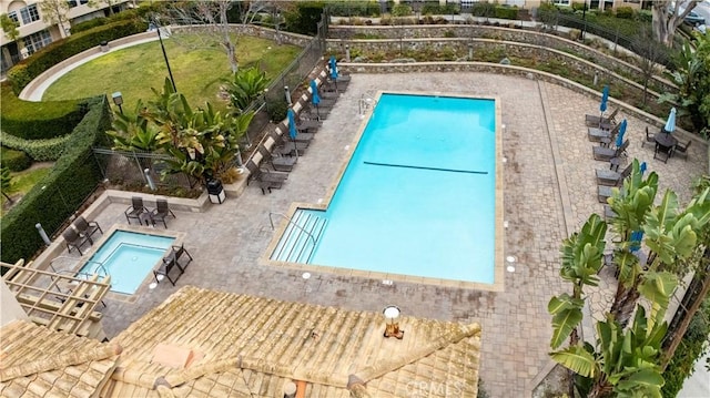 view of pool featuring a hot tub and a patio